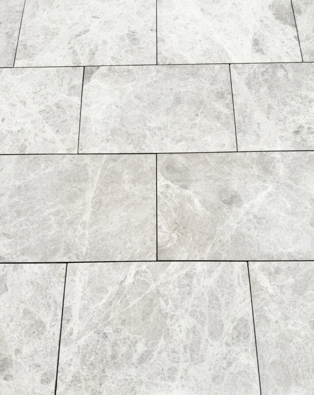 Luna Grey Marble pavers featuring light grey tones with bold white veining in a staggered layout.