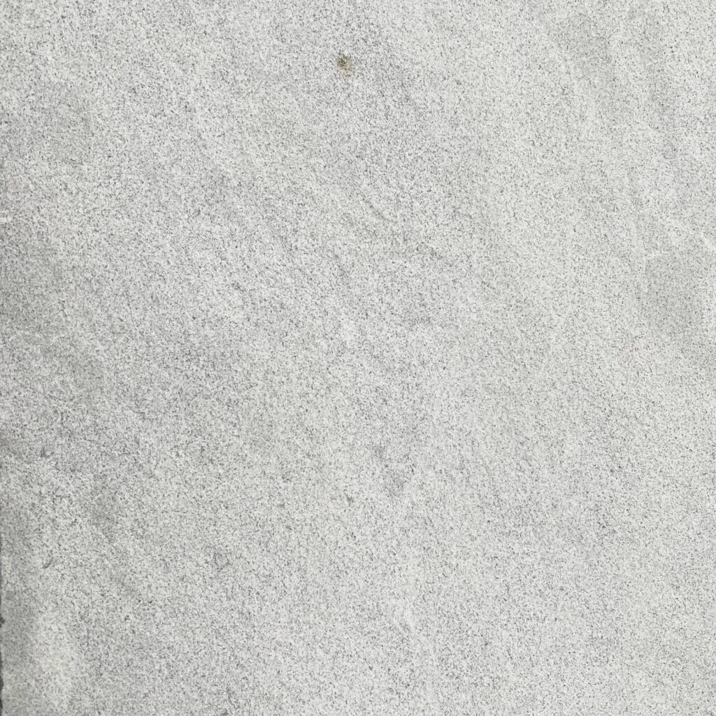 Close-up of Provincial Marble pavers with a soft, speckled grey finish.