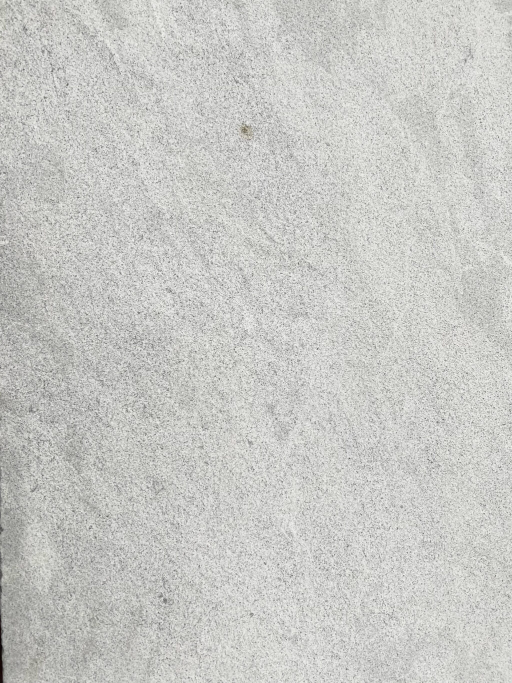 Close-up of Provincial Marble pavers with a soft, speckled grey finish.