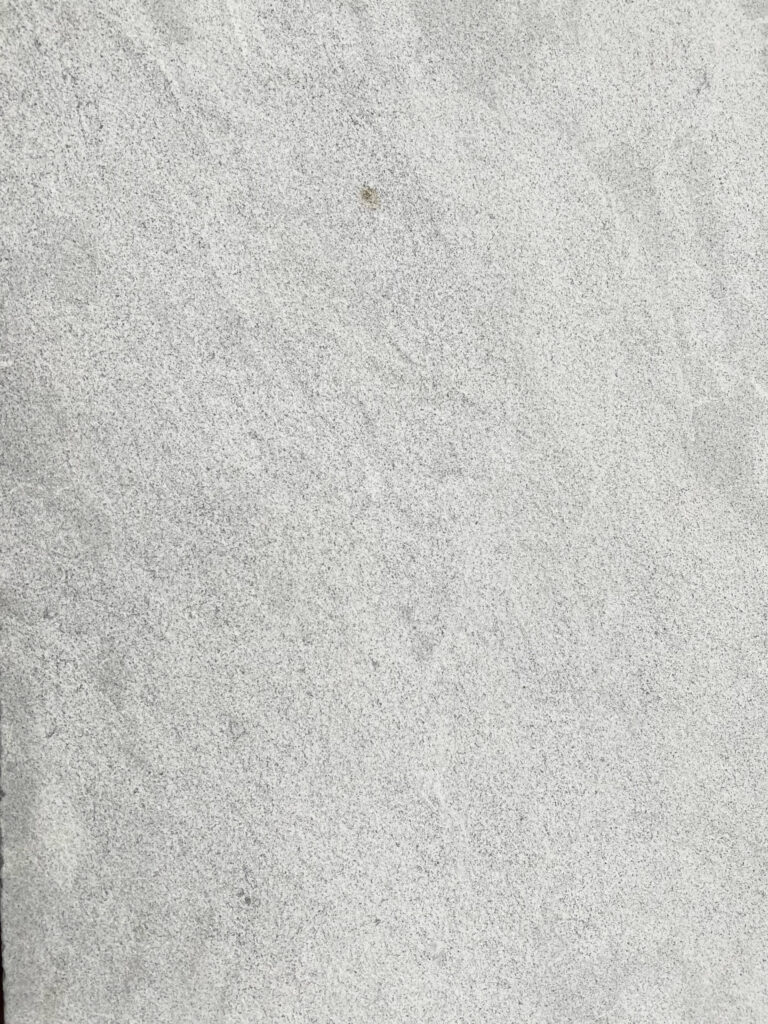 Close-up of Provincial Marble pavers with a soft, speckled grey finish.