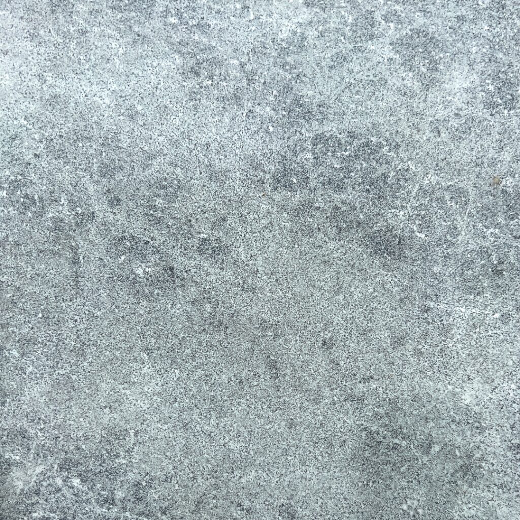 Close-up of Ocean Grey Marble paver with fine-grained texture and deep grey speckling.