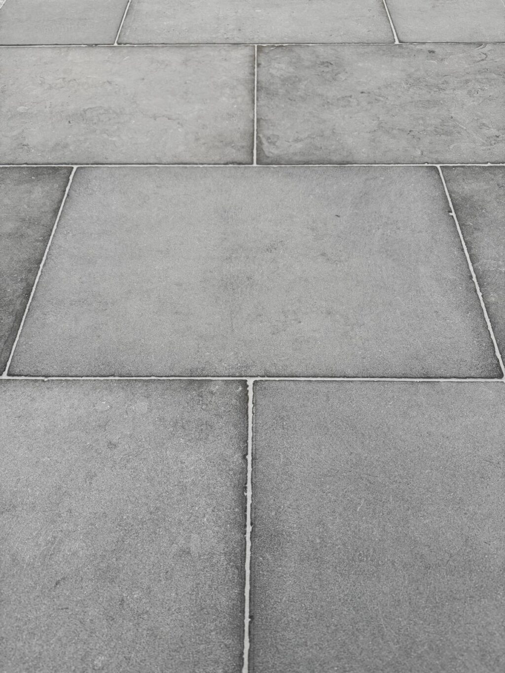 Close-up of Loch Limestone pavers featuring a cool grey tone, clean edges, and a lightly textured surface for a refined finish.