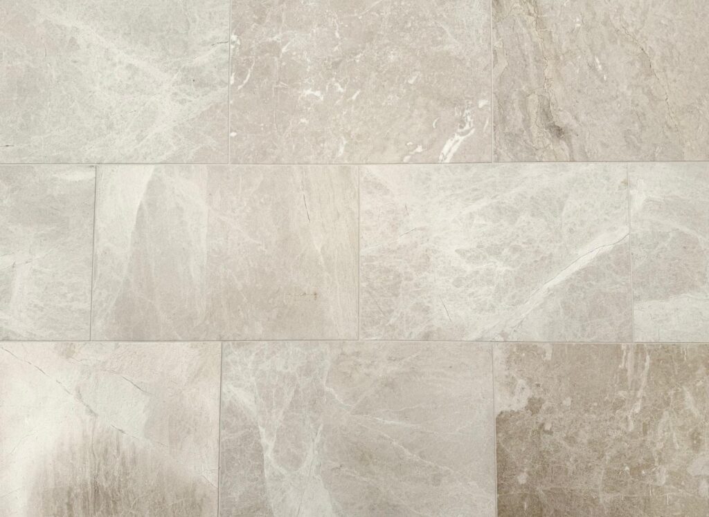 Serra Marble tiles in soft beige tones with subtle white veining, perfect for refined indoor or outdoor surfaces.