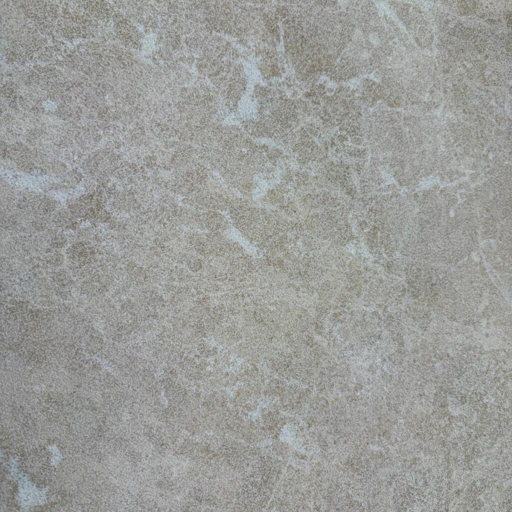 Close-up of Serra Marble with beige tones and soft white marbled veining.