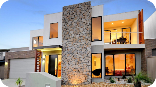 he front exterior of a modern two-story home at dusk, featuring a prominent central column clad in irregular natural stone.