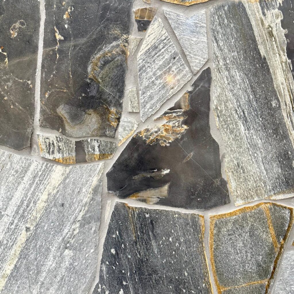 Zeel Quartz stone with grey, black, and golden tones in irregular patterns