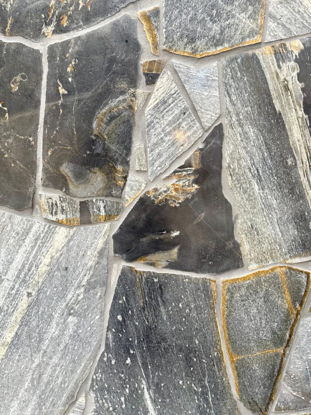Zeel Quartz stone with grey, black, and golden tones in irregular patterns