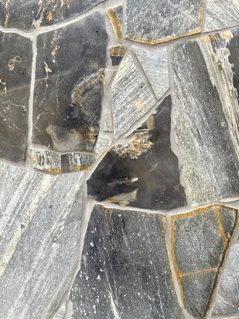 Zeel Quartz stone with grey, black, and golden tones in irregular patterns