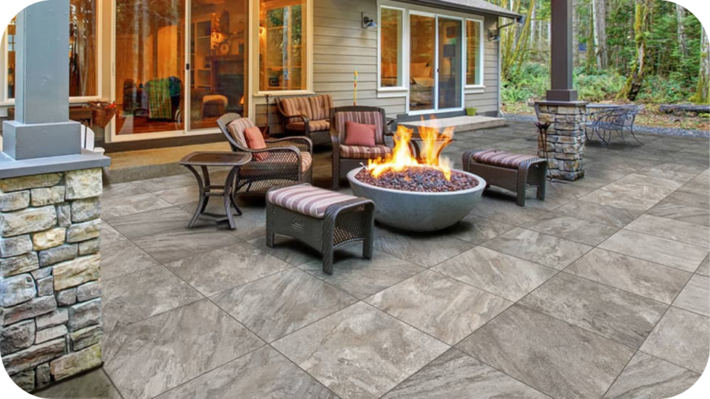 Outdoor patio with natural stone pavers and fire pit, creating a warm seating area that highlights the durability of stone paving.