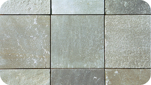 Detailed view of square quartzite pavers with subtle grey variations, showing the stone’s texture and strength for long-lasting residential and commercial paving.