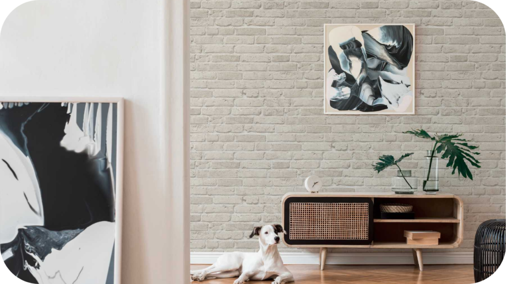 Living room with Ashbury brick feature wall, modern artwork, wooden console, and a relaxed dog, creating a warm contemporary design.