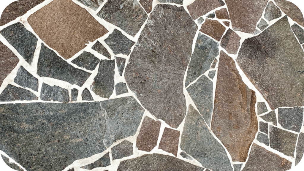 Close-up of crazy porphyry stone pavers in mixed earthy tones, highlighting the rugged textures and natural strength of this versatile paving material.