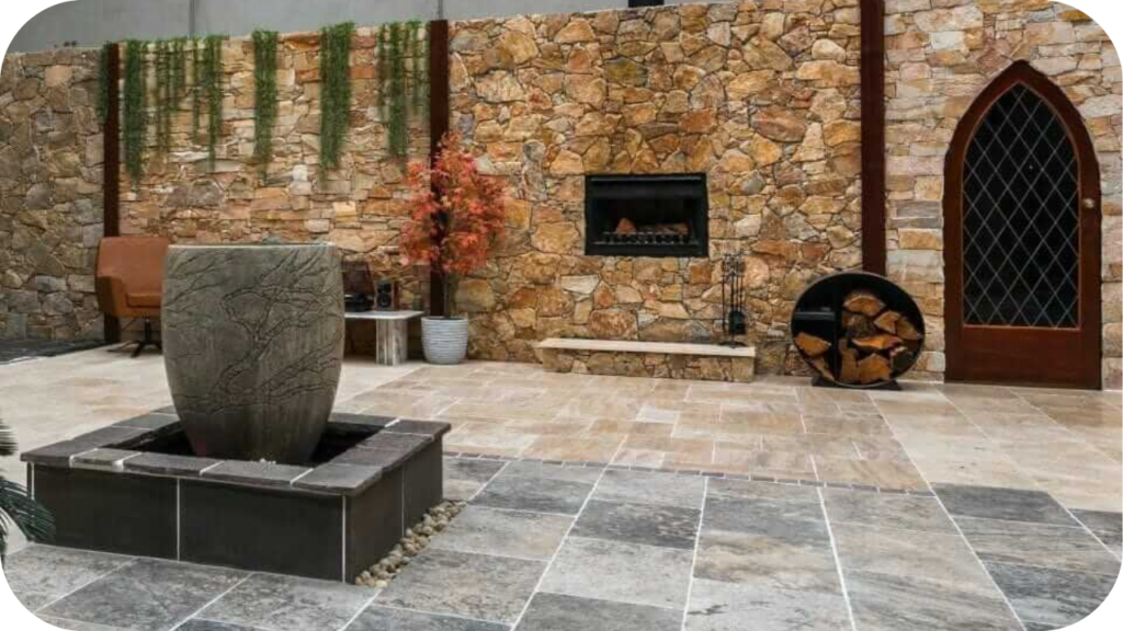 Splendour in Stone showroom featuring natural stone walls and patterned paving, displaying porphyry and other stones in a stylish indoor design setting.