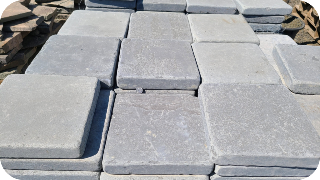 Stacked bluestone pavers ready for installation, showcasing durability, consistent cuts, and natural grey-blue tones.
