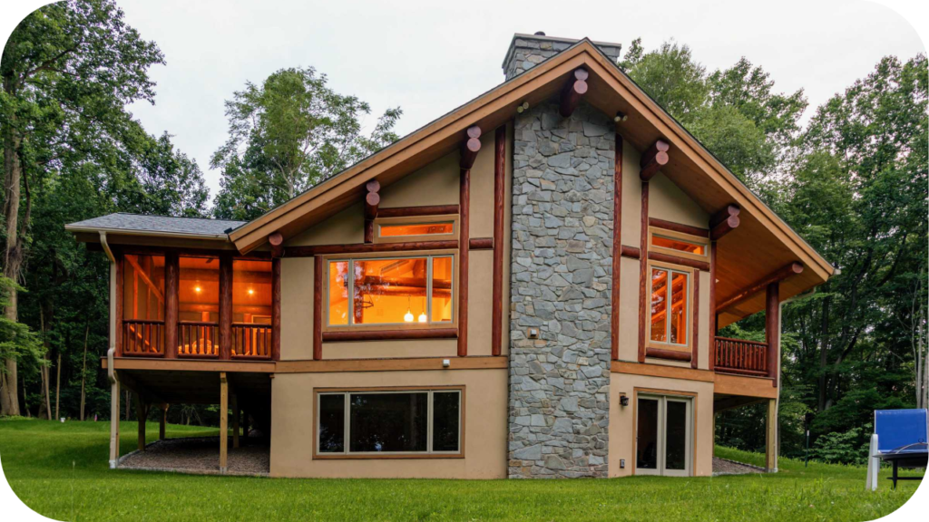 Rustic home exterior with a tall central stone chimney and timber details, illustrating how natural stone defines timeless architectural style.