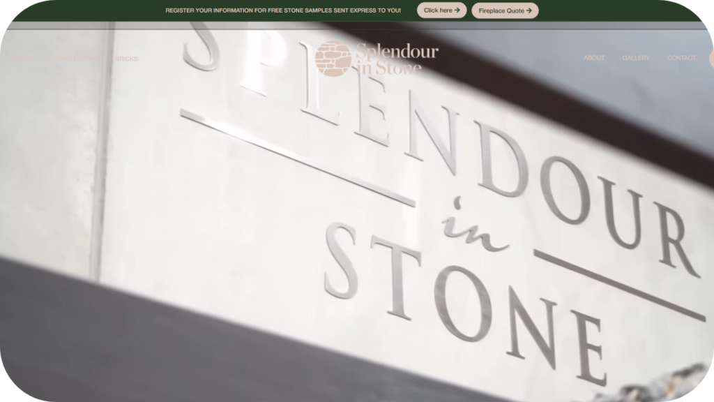 Close-up of the Splendour in Stone signage engraved on a polished stone wall, representing a premium natural stone supplier.