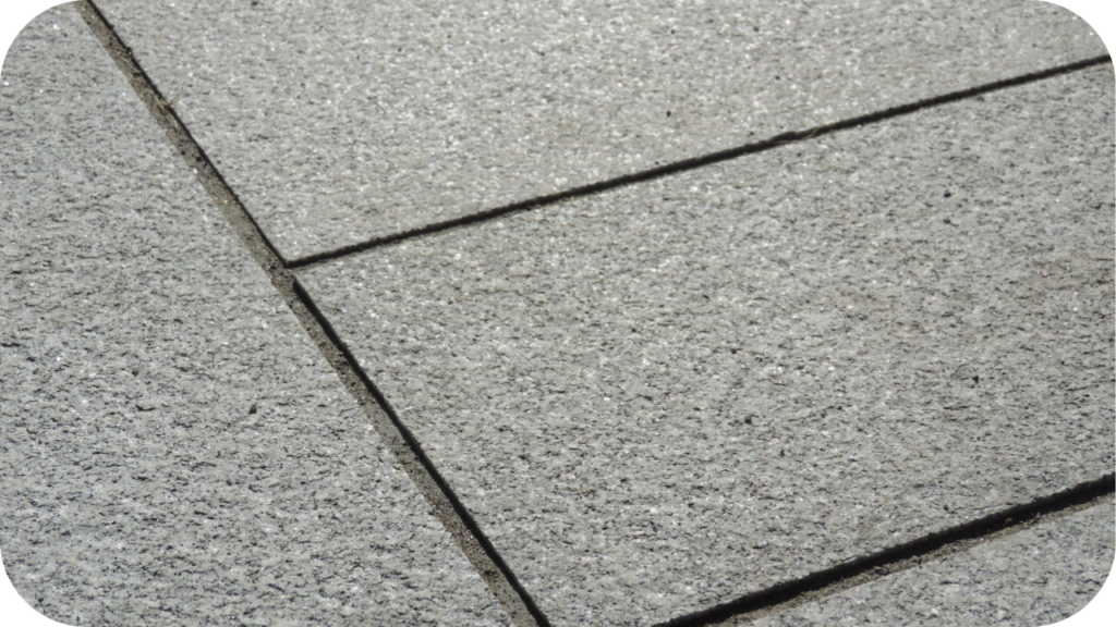 Close-up view of textured granite pavers showing their natural grip and dense mineral structure used for strong outdoor surfaces in Australian climates.