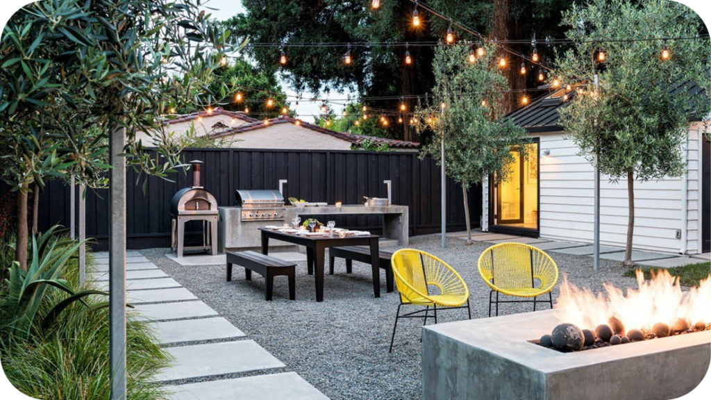 Contemporary outdoor entertaining area with gravel paving, string lights, seating and a fire feature, offering inspiration for DIY backyard improvements.