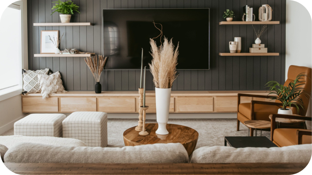 Modern living room with a dark timber feature wall, mounted TV, floating shelves, and warm furnishings creating a clean, balanced contemporary design.